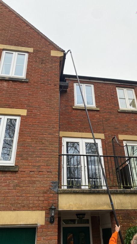 pole up to gutter, front of house with balcony and windows