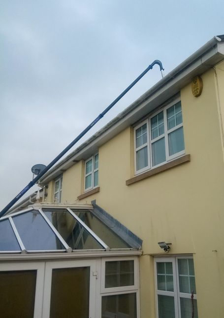 conservatory on back of house with pole going up to gutter