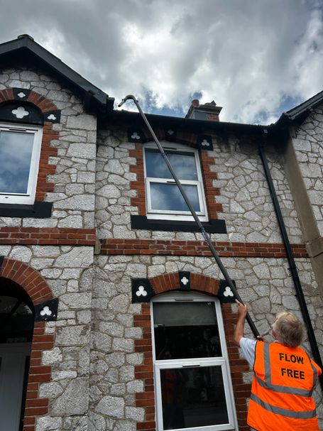 man with pole, gutter, front of house
