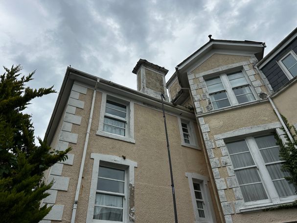 side of house with pole to gutter