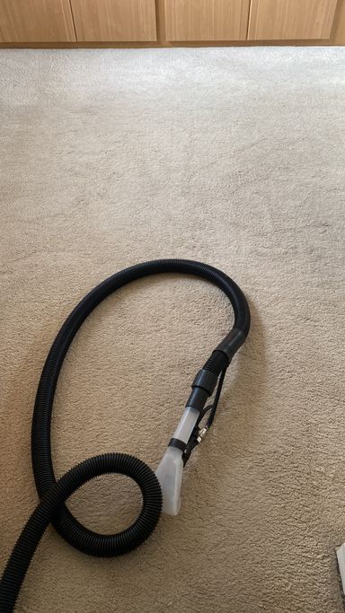 carpet cleaner pipe on cream carpet