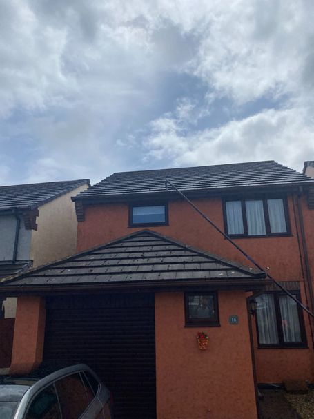 front of house with garage, roof, windows