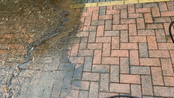 brick driveway part way through pressure washing