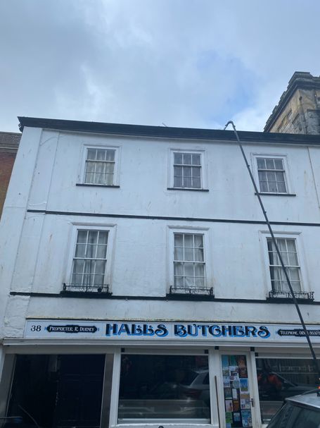 Front of shop with windows, wall, gutter