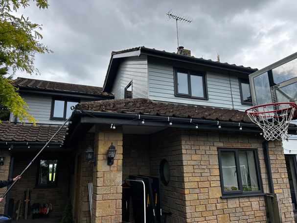 house with porch, garage roof, windows, cladding