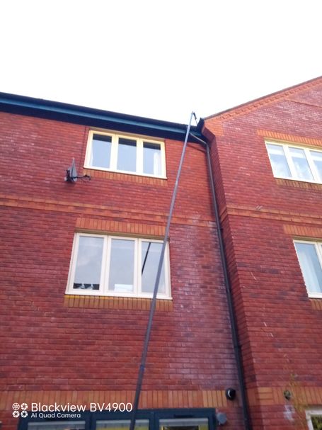 cleaning pole at back of three storey house